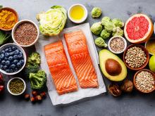 Healthy foods, including salmon, fruits, nuts, and whole grains
