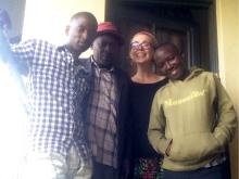 Returned Peace Corps Volunteer Caitrin Riddle with friends and host in Uganda