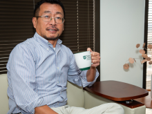 Lu Qi poses with a coffee mug