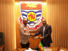Dean LaVeist shaking hands over signed documents at U Cape Coast