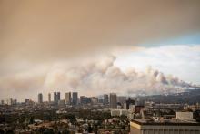 A city skyline covered in smog and smoke.