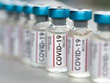 Stock photo of bottles labeled Covid vaccine