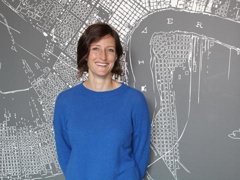 Johanna NIce photo standing in front of a map of New Orleans