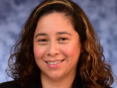 Kelly Bernabe, smiling at camera, headshot