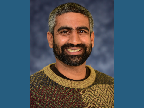 Hans DeSale, PhD student, Department of Tropical Medicine Photo Of Hans DeSale, smiling, wearing gold and brown sweater
